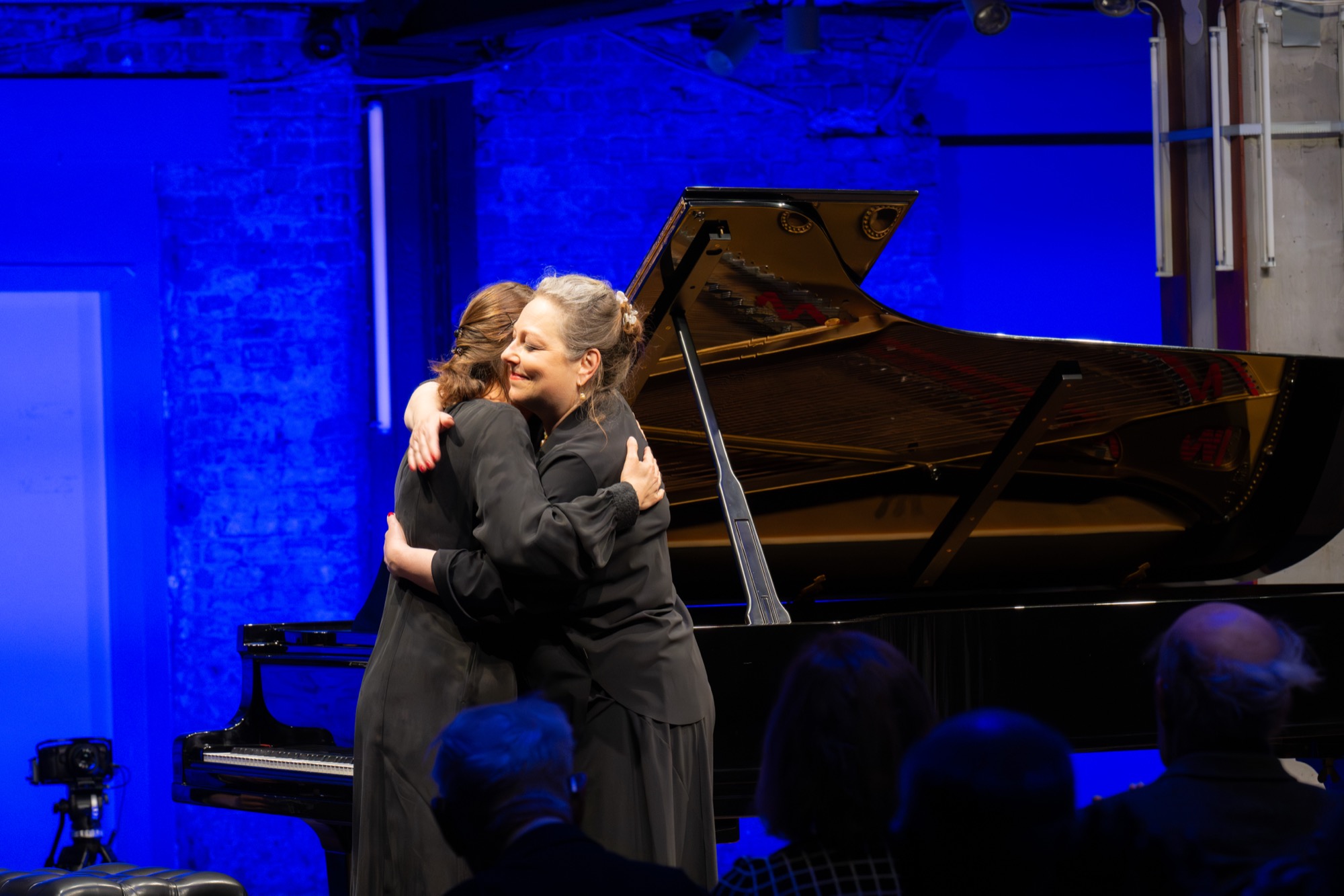Sharing a warm embrace with a singer after a concert